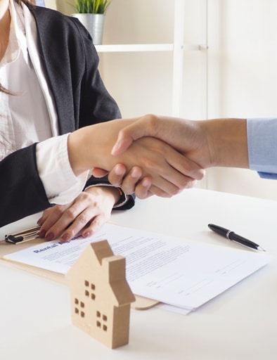 Customer shaking hand with agency of a real estate company after